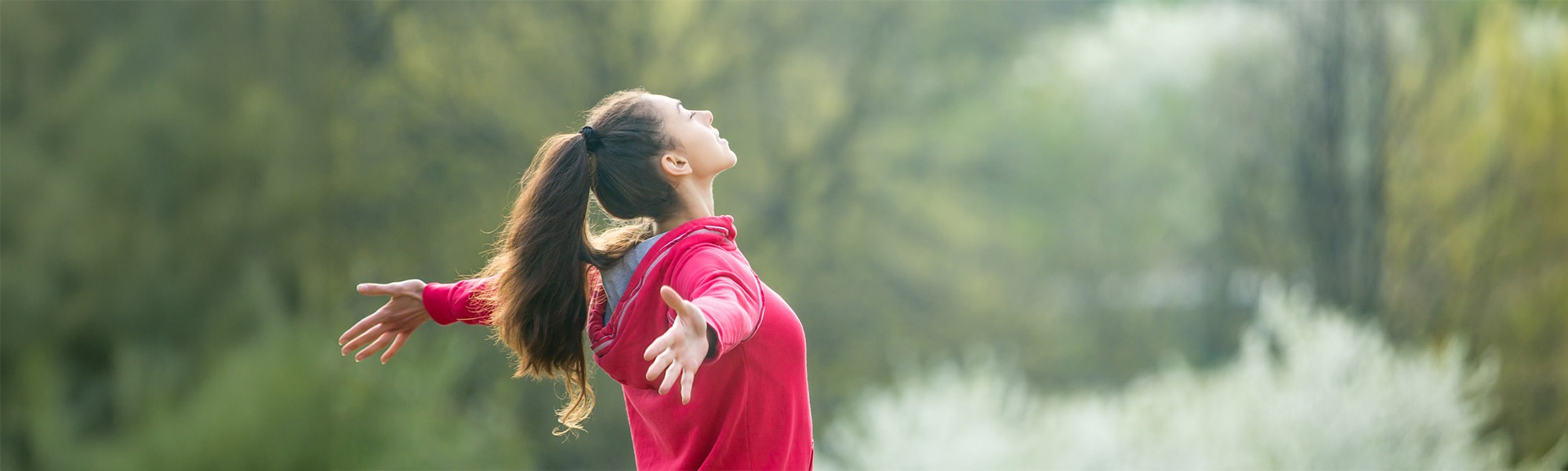 Woman spreading arms feeling the nature